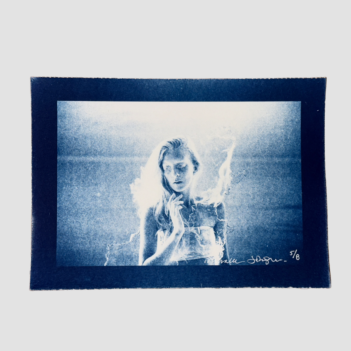 Cyanotype depicting a portrait of ionnalee in front of a lake, by John Strandh