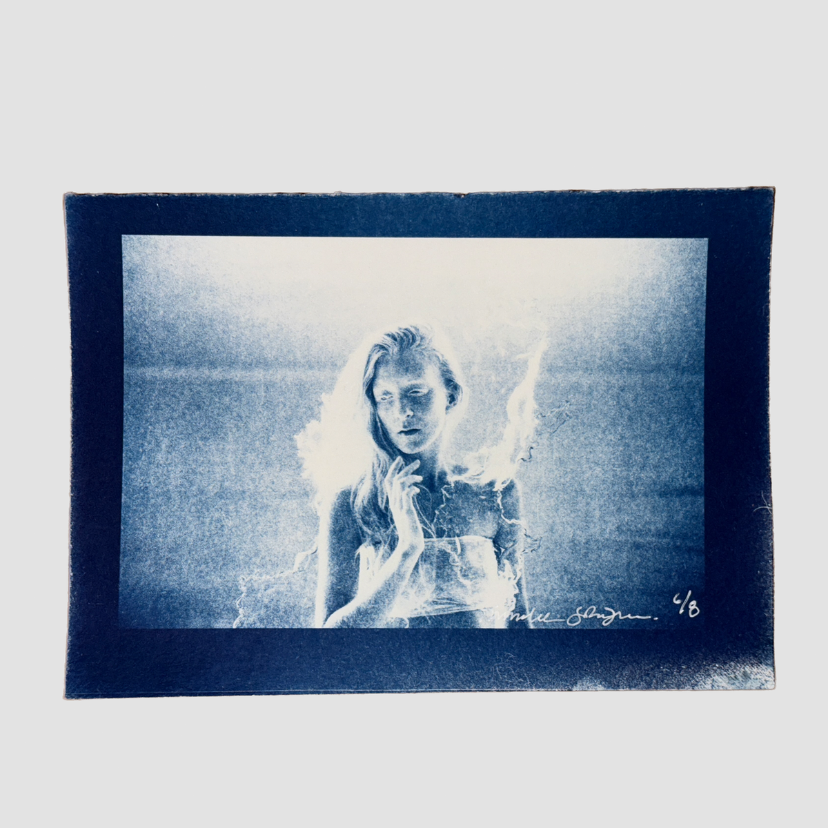 Cyanotype depicting a portrait of ionnalee in front of a lake, by John Strandh