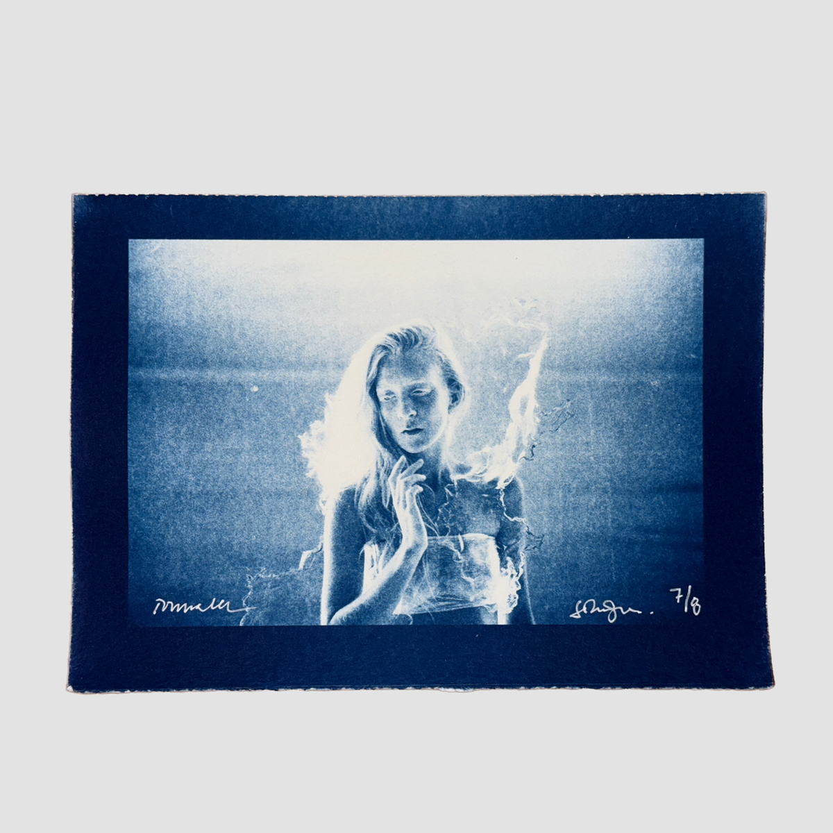 Cyanotype depicting a portrait of ionnalee in front of a lake, by John Strandh