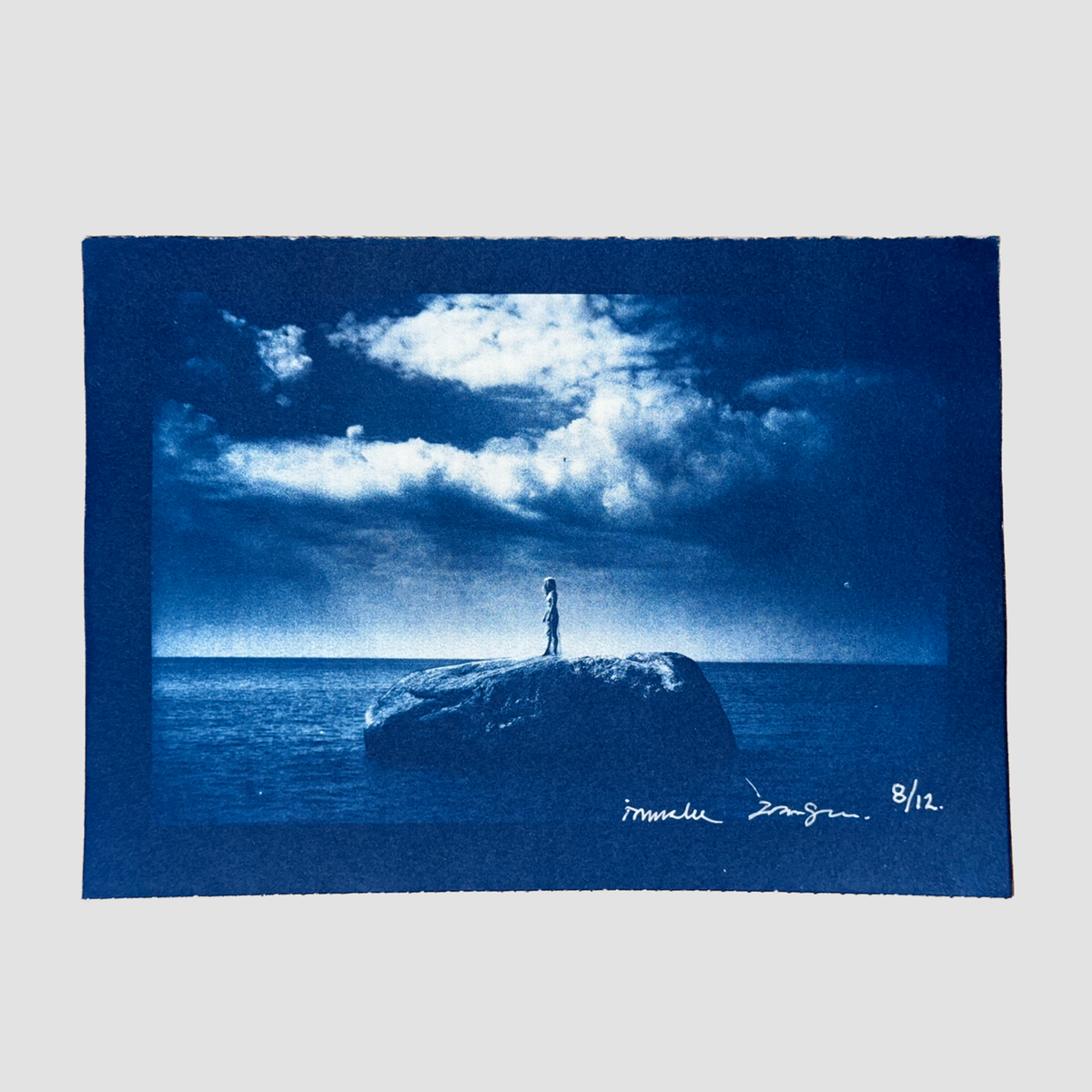 Cyanotype depicting ionnalee standing on a rock in a lake, by John Strandh
