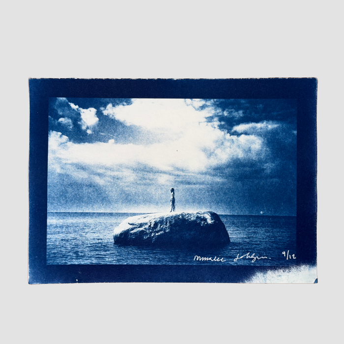 Cyanotype depicting ionnalee standing on a rock in a lake, by John Strandh